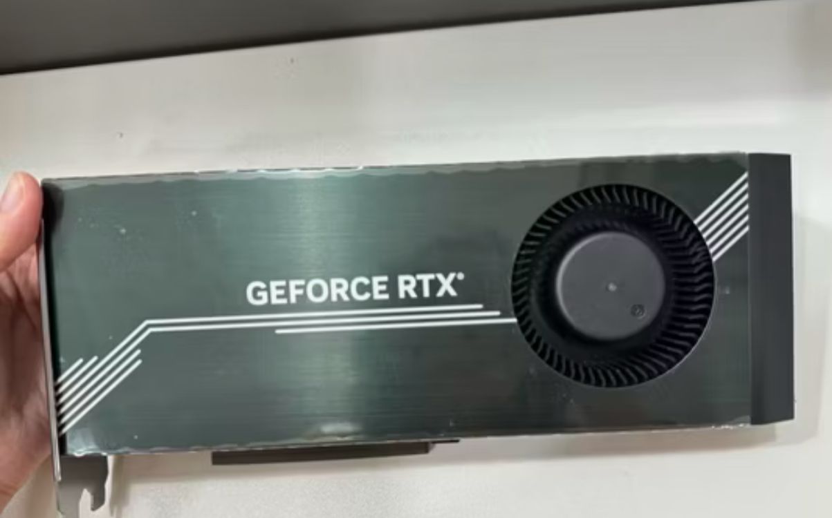 GeForce RTX blower-style card in hand